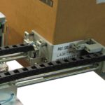 Sistema stampa e applica per applicazione etichetta su due lati di una scatola